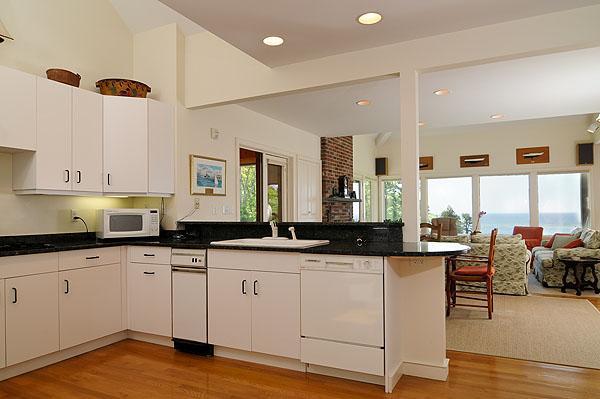 48 Bourne Point Road Wareham, MA 02571 - Photo 13 of 23 a kitchen with granite countertop a sink cabinets and wooden floor
