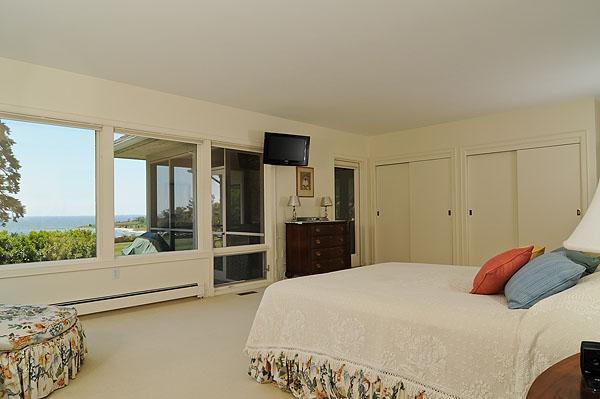 48 Bourne Point Road Wareham, MA 02571 - Photo 15 of 23 a bedroom with a large bed and a large window