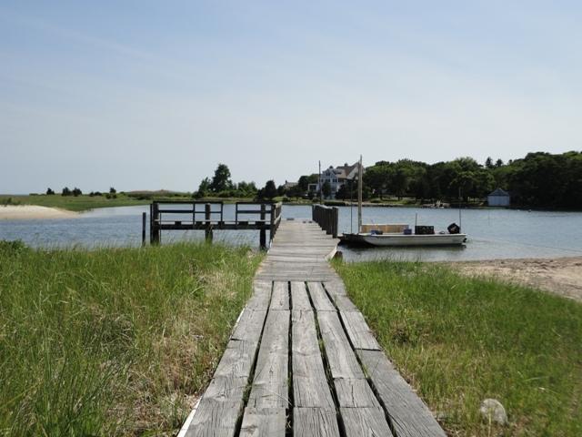 48 Bourne Point Road Wareham, MA 02571 - Photo 21 of 23 a view of a lake with a bench in front of it