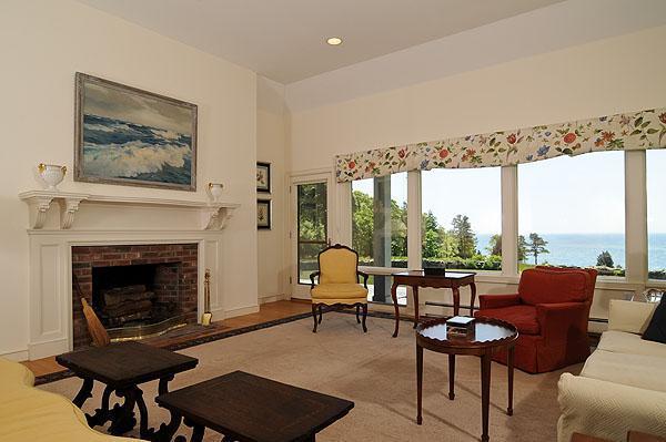 48 Bourne Point Road Wareham, MA 02571 - Photo 5 of 23 a living room with furniture a fireplace and a floor to ceiling window