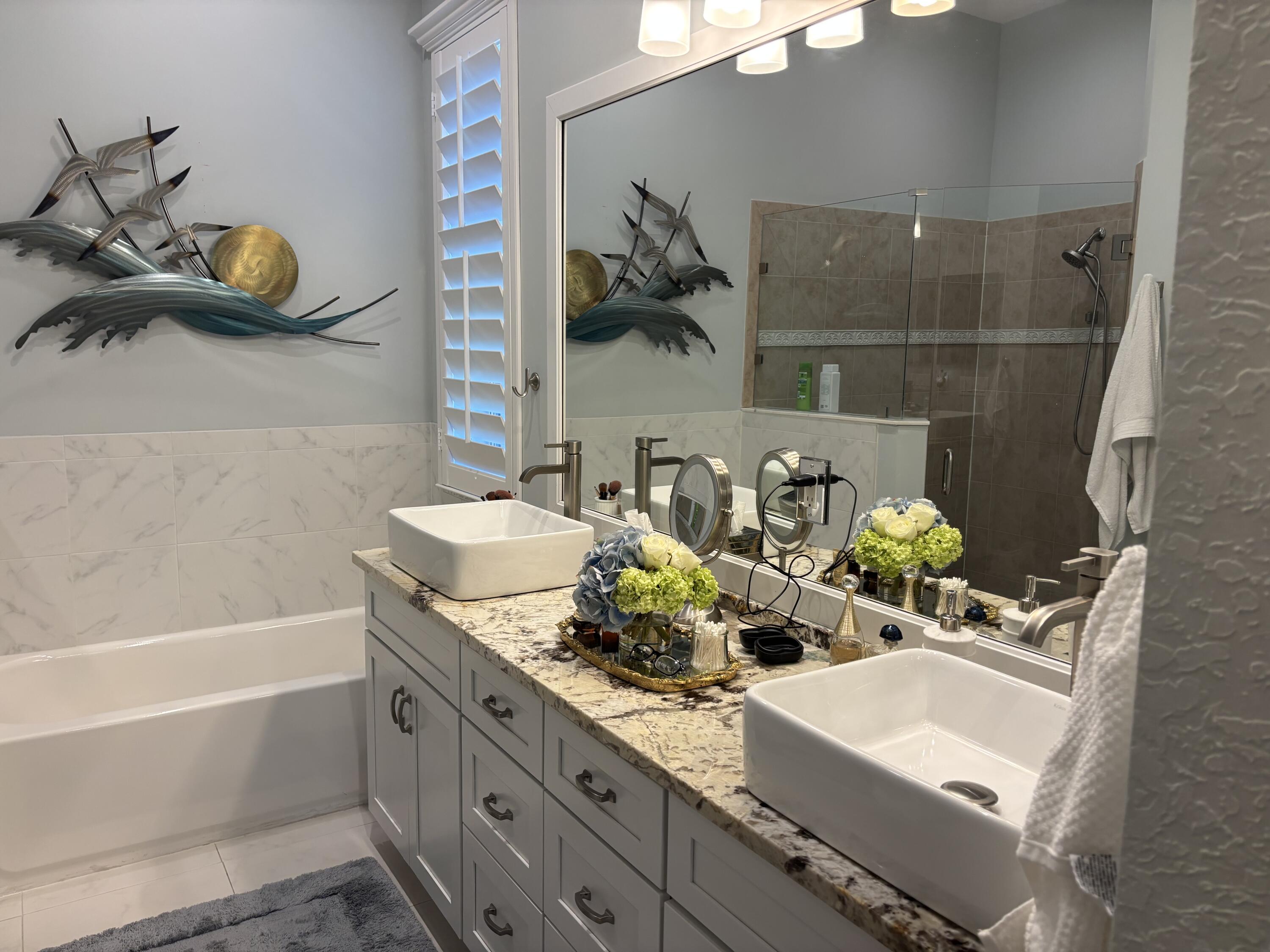 140 Via Rosina Jupiter, FL 33458 - Photo 11 of 16 a bathroom with a sink and a mirror