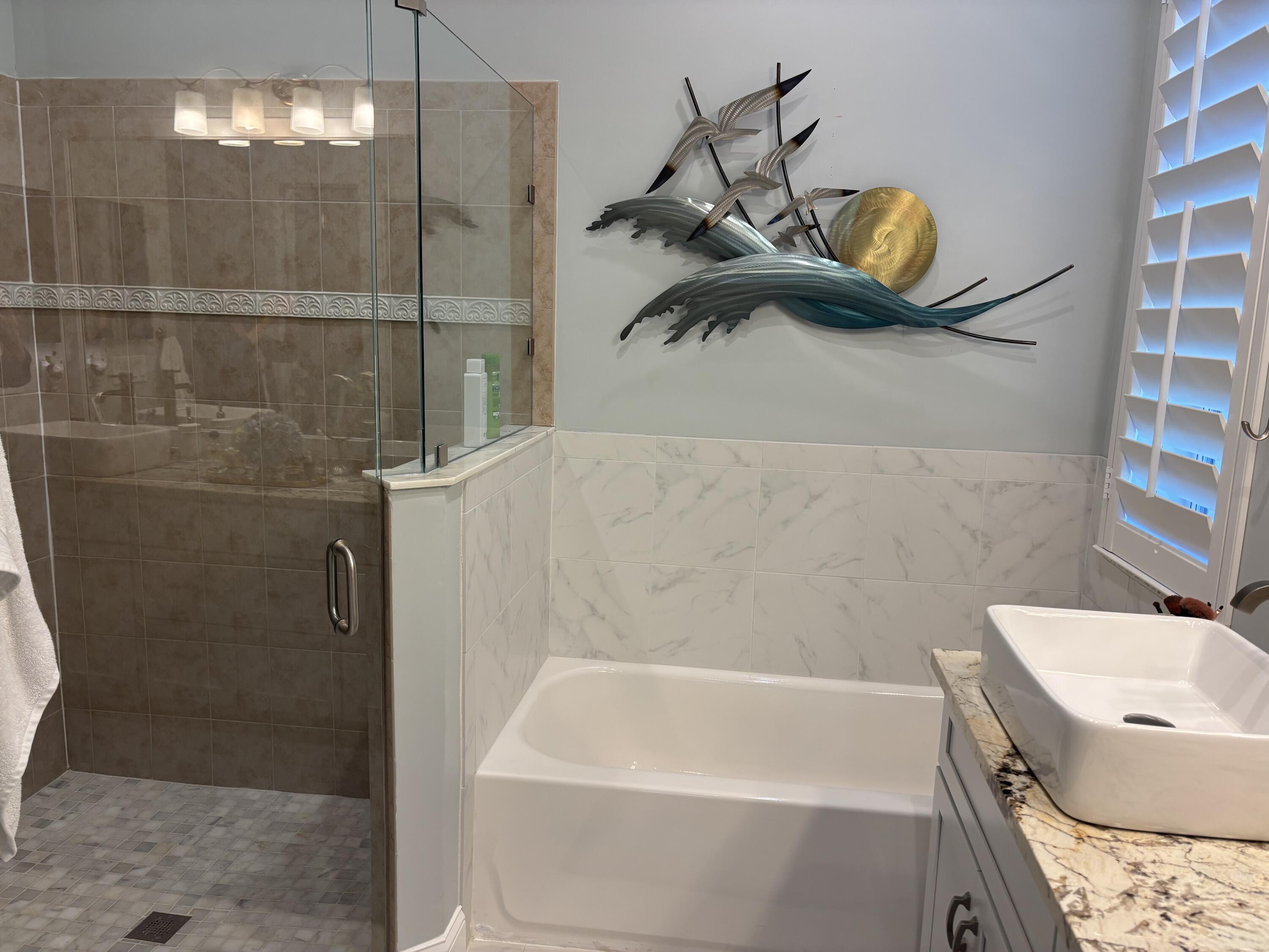 140 Via Rosina Jupiter, FL 33458 - Photo 12 of 16 a bathroom with a tub and a shower