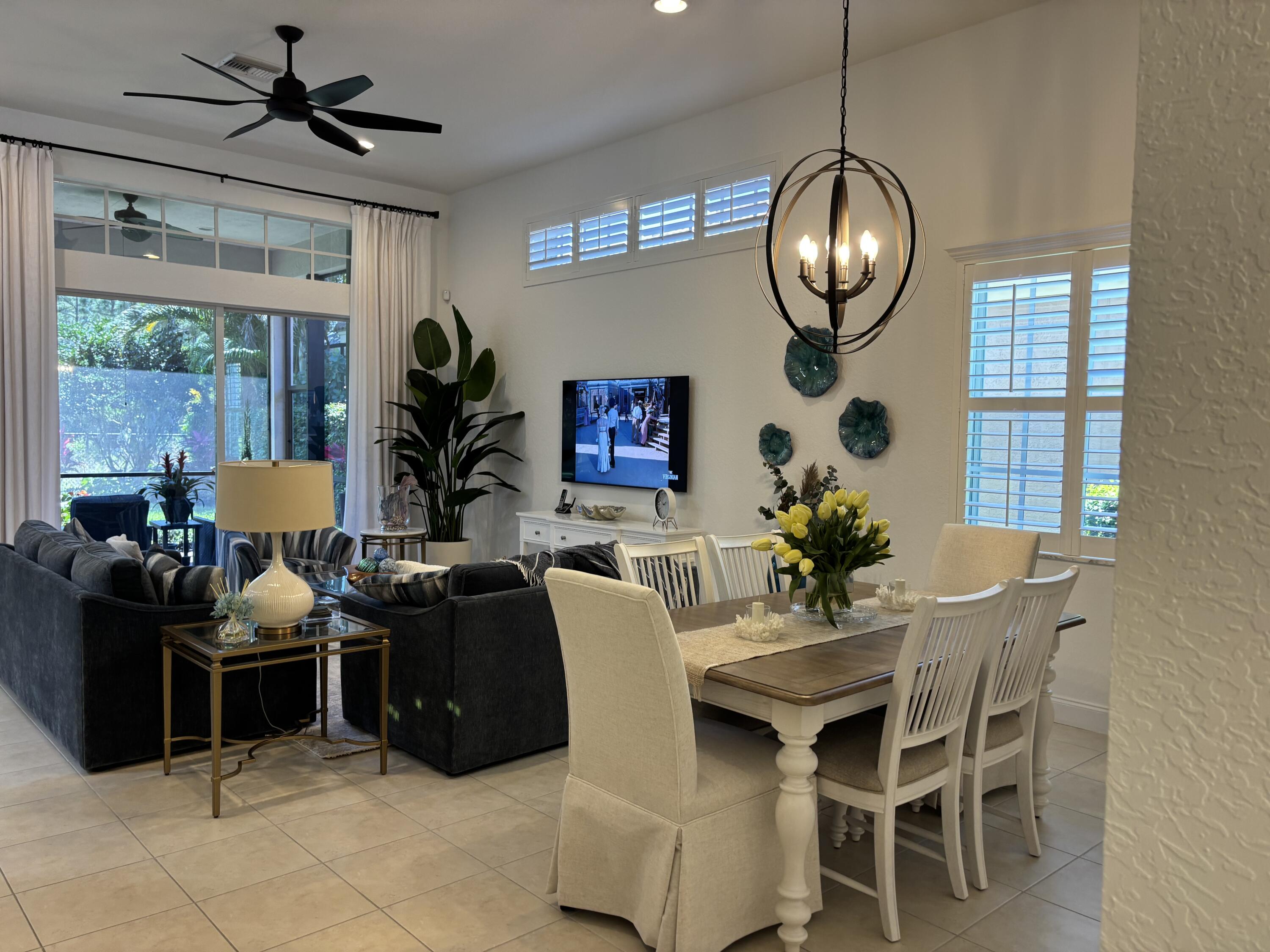140 Via Rosina Jupiter, FL 33458 - Photo 3 of 16 a dining room with furniture a chandelier and window