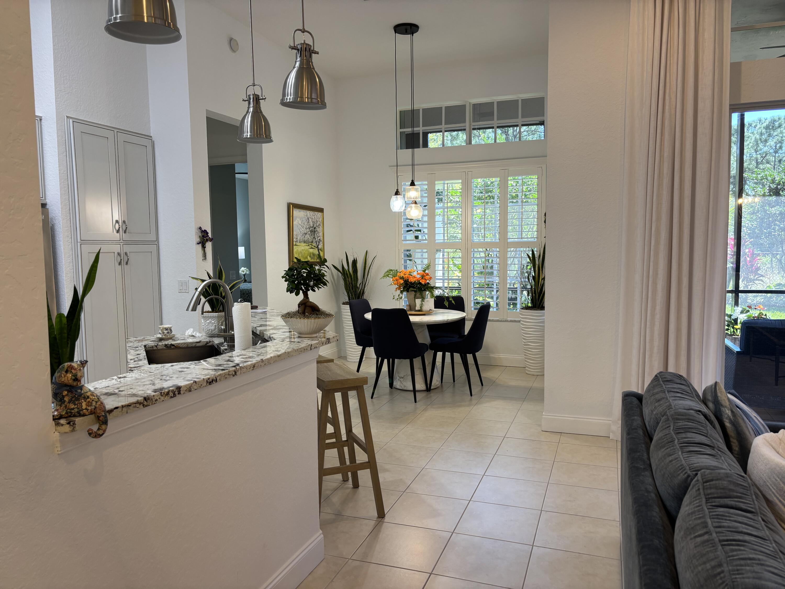 140 Via Rosina Jupiter, FL 33458 - Photo 5 of 16 a living room with furniture a window and a chandelier