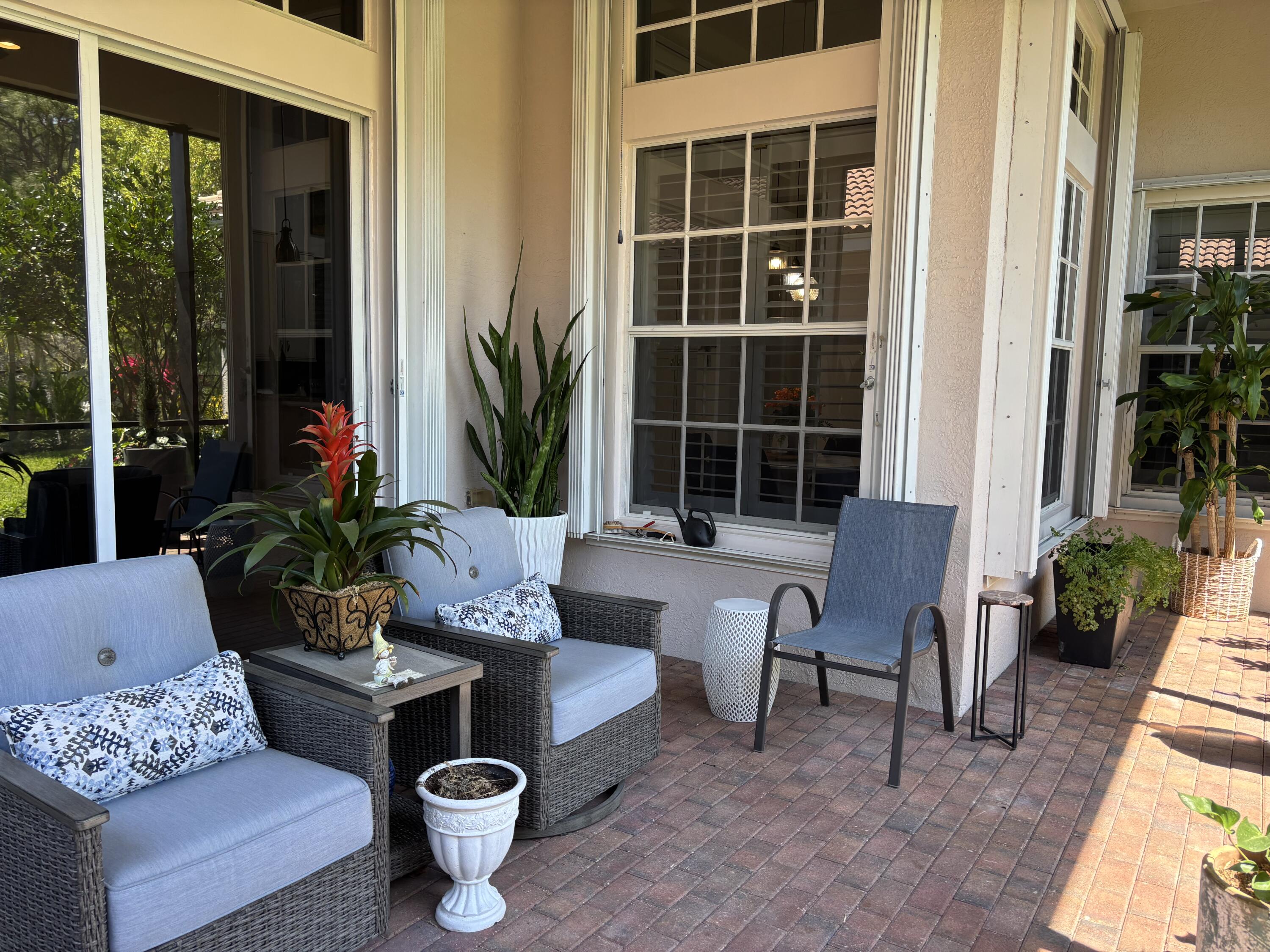 140 Via Rosina Jupiter, FL 33458 - Photo 6 of 16 a view of a patio with couches potted plants and a large window