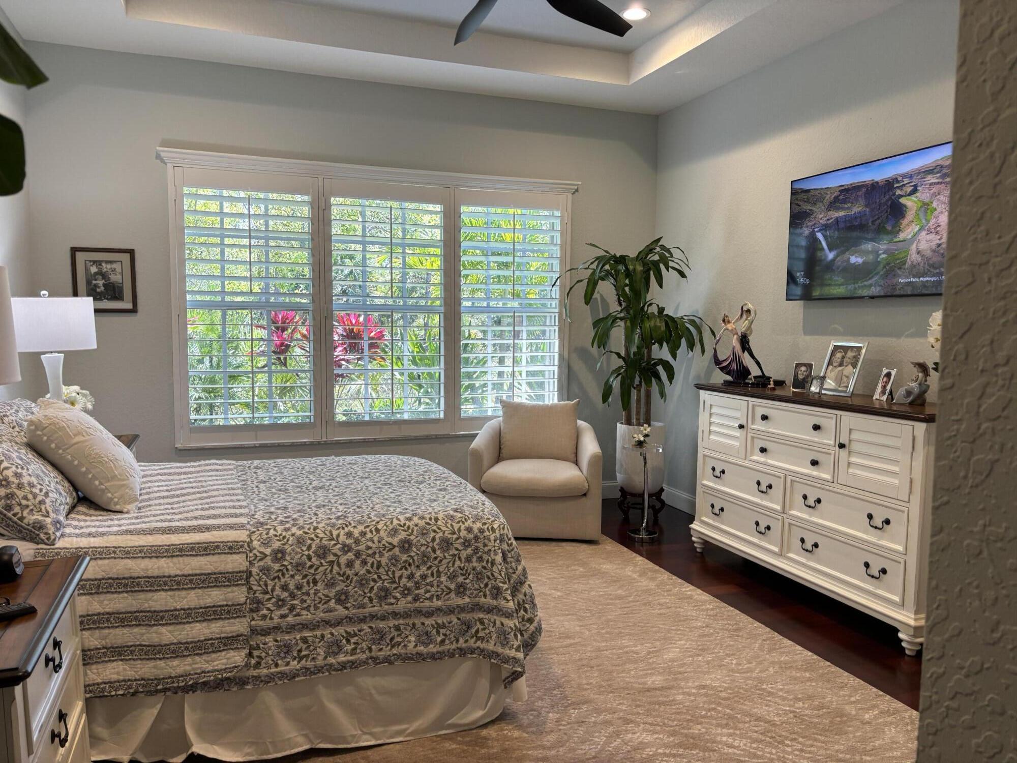 140 Via Rosina Jupiter, FL 33458 - Photo 7 of 16 a bedroom with a bed and a dresser next to a window