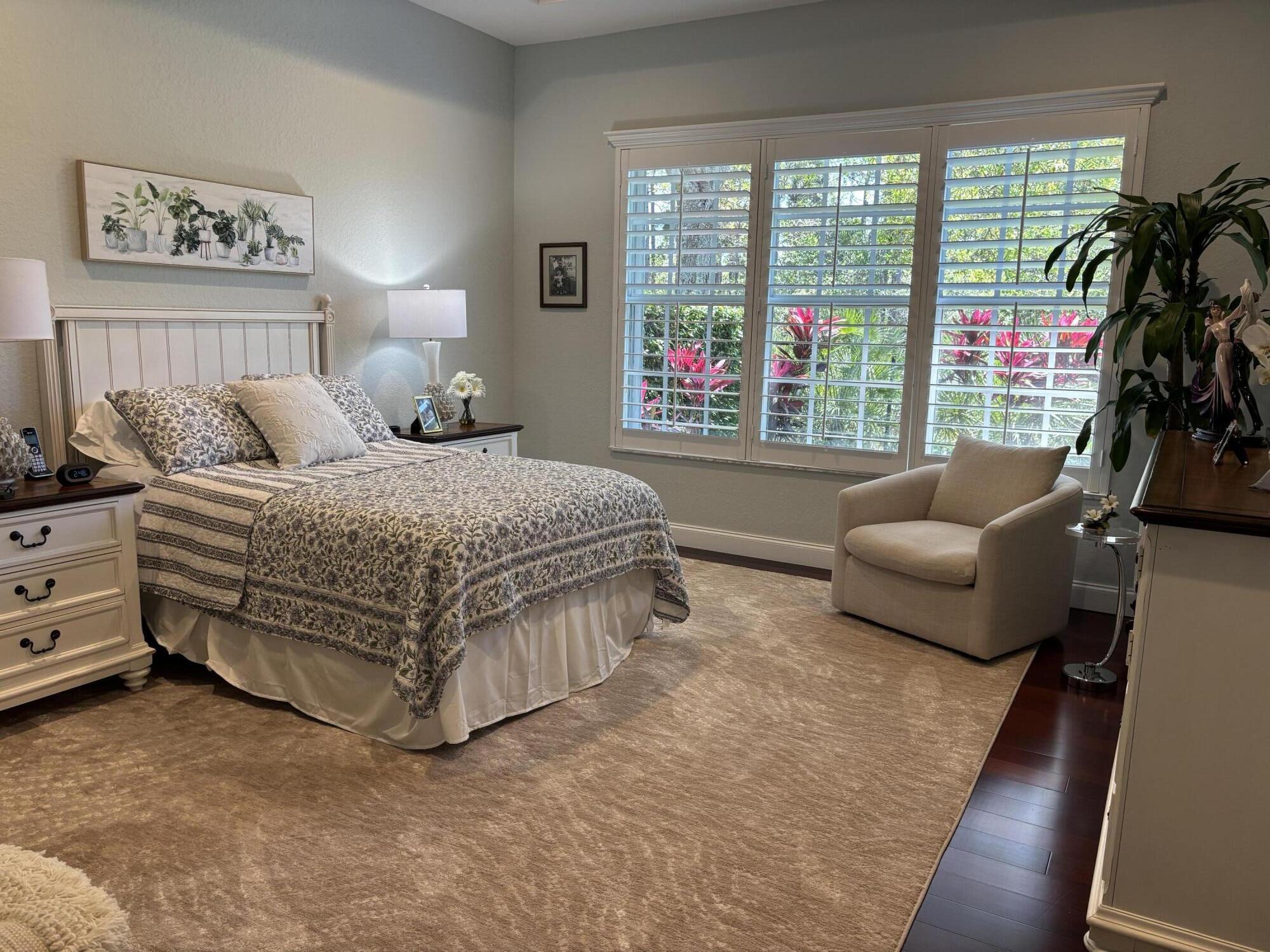 140 Via Rosina Jupiter, FL 33458 - Photo 9 of 16 a bedroom with a bed and a couch next to a window