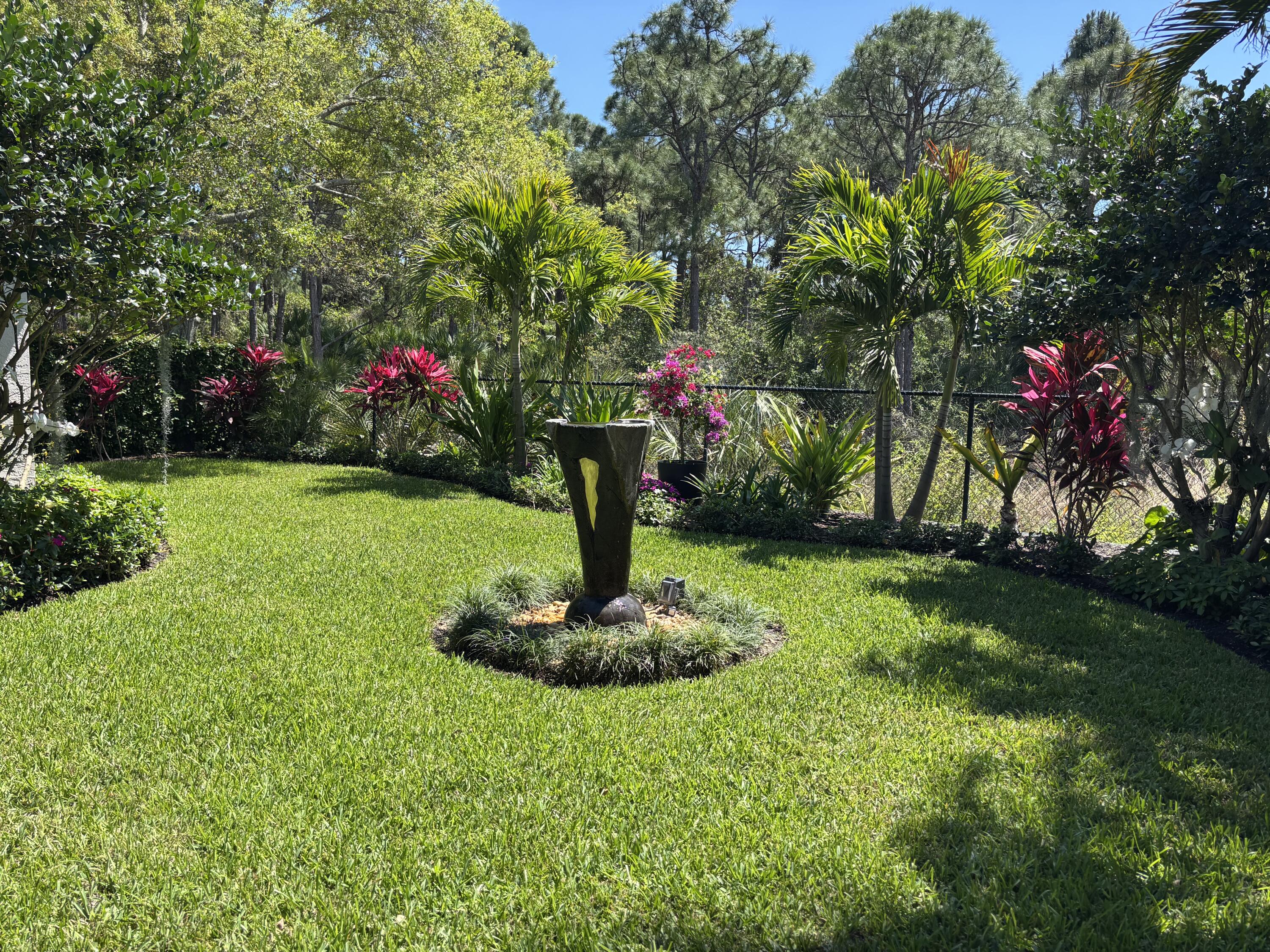 140 Via Rosina Jupiter, FL 33458 - Photo 10 of 16 a front view of a house with a yard and fountain