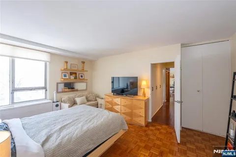 a bedroom with a bed and a television