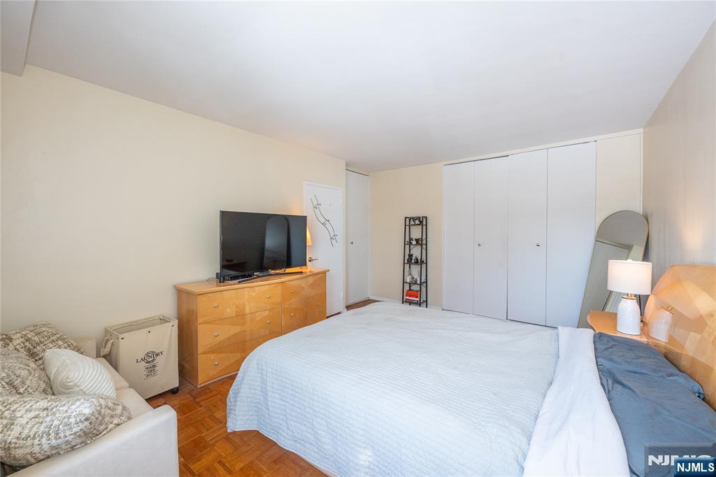 1 Horizon Road, Unit 403 Fort Lee, NJ 07024 - Photo 16 of 29 a bedroom with a bed and a television