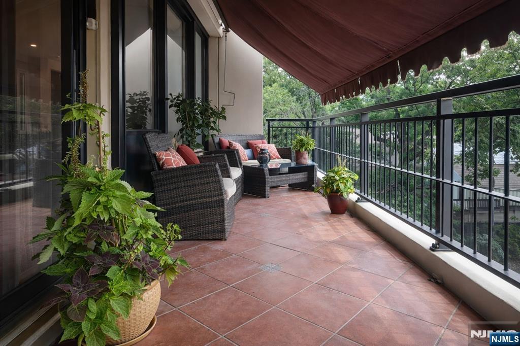 1 Horizon Road, Unit 403 Fort Lee, NJ 07024 - Photo 8 of 29 a view of a deck with couches and potted plants