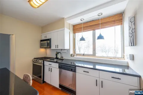 a kitchen with a sink cabinets and window