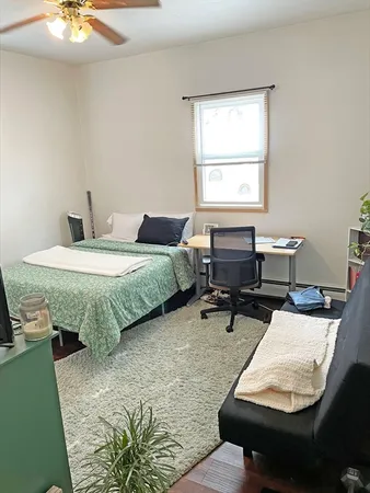 a bed room with a bed and a window