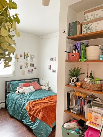 a bedroom with large bed and a book shelf