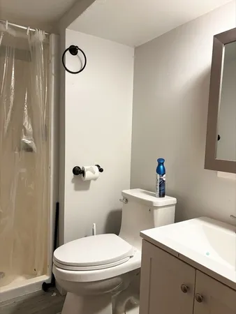 a white toilet sitting next to a bathroom sink