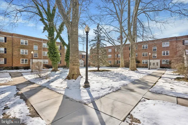 a pathway of a house with a yard covered in snow