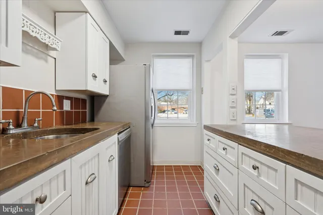 a kitchen with granite countertop a sink and a stove