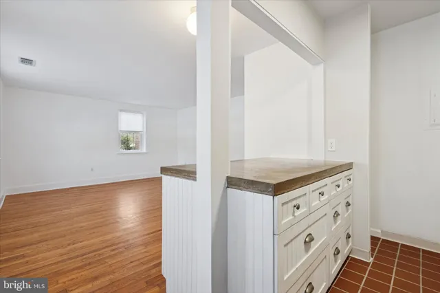a view of a kitchen with wooden floor and electronic appliances