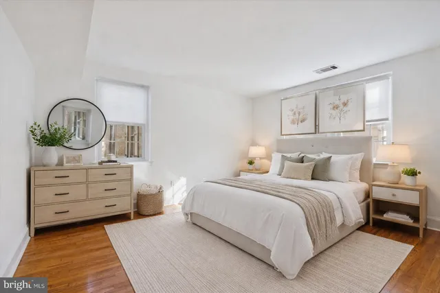 a view of empty room with wooden floor and window