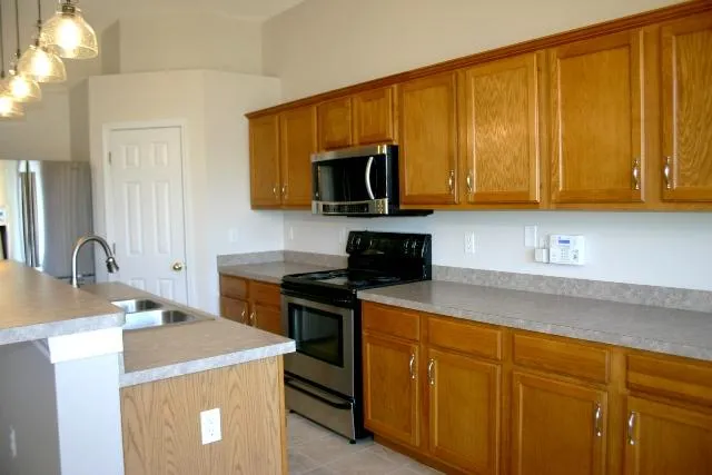 a kitchen with a sink and a stove top oven