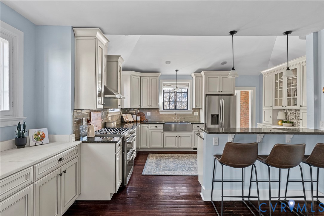 803 Spottswood Road Richmond, VA 23220 - Photo 11 of 50 a kitchen with cabinets and chairs