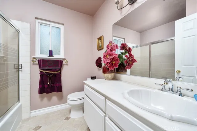 a view of a patio with table and chairs under an umbrella