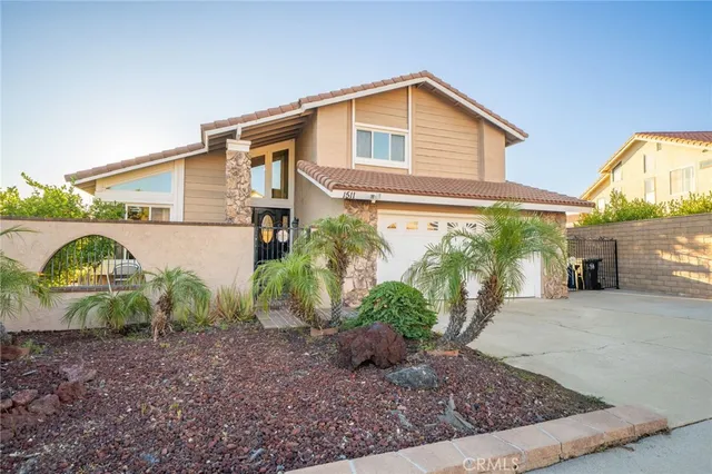 a view of a house with a yard and garage