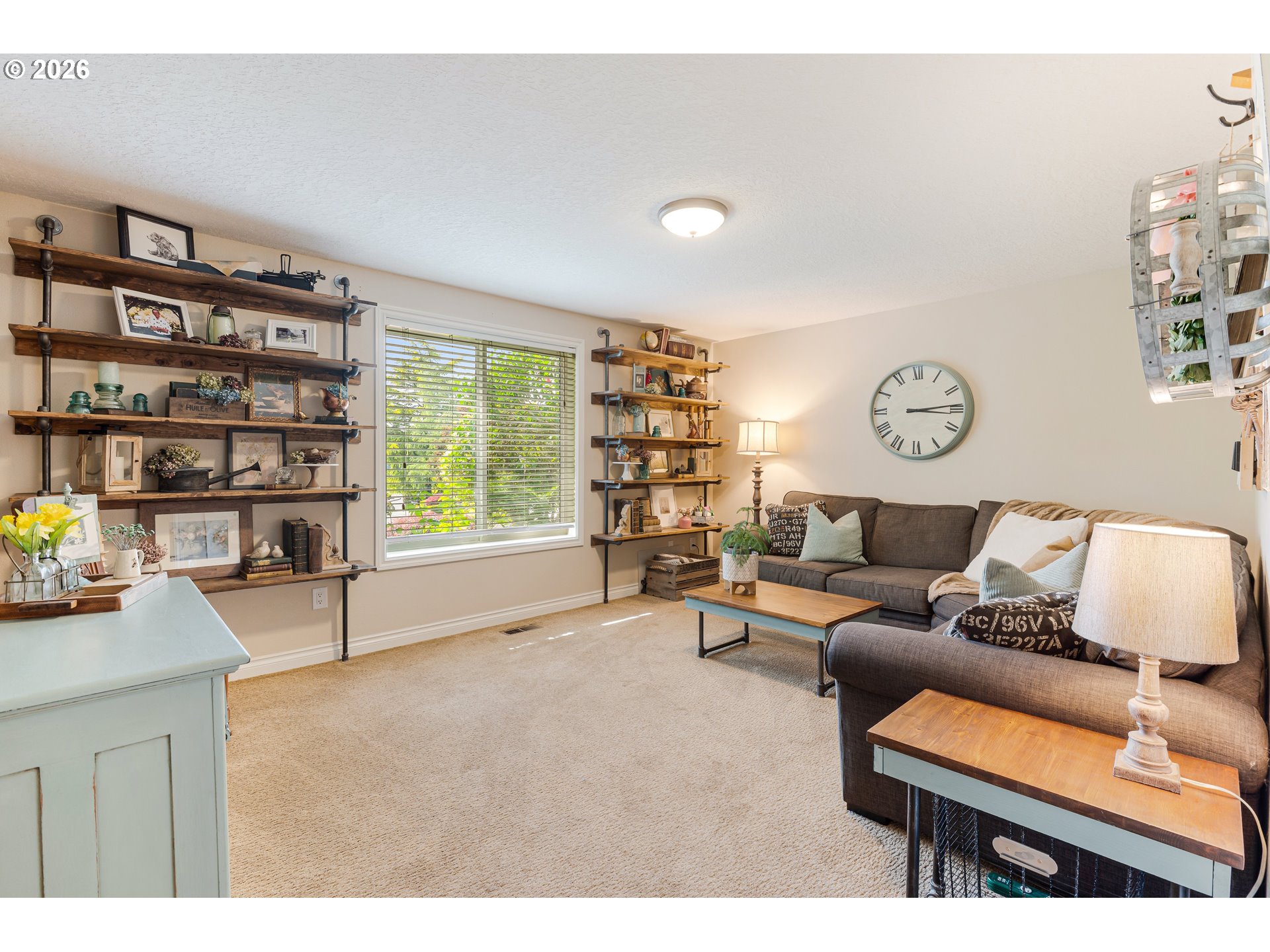 7680 Southwest 182nd Place Beaverton, OR 97007 - Photo 11 of 33 a living room with furniture and a book shelf
