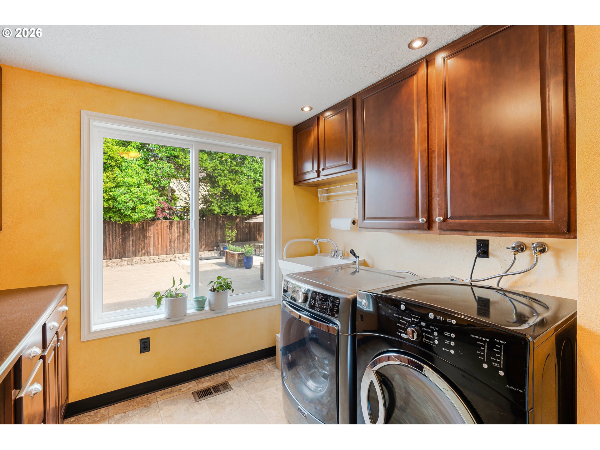 7680 Southwest 182nd Place Beaverton, OR 97007 - Photo 13 of 33 a utility room with granite countertop a sink a washer and dryer next to a window
