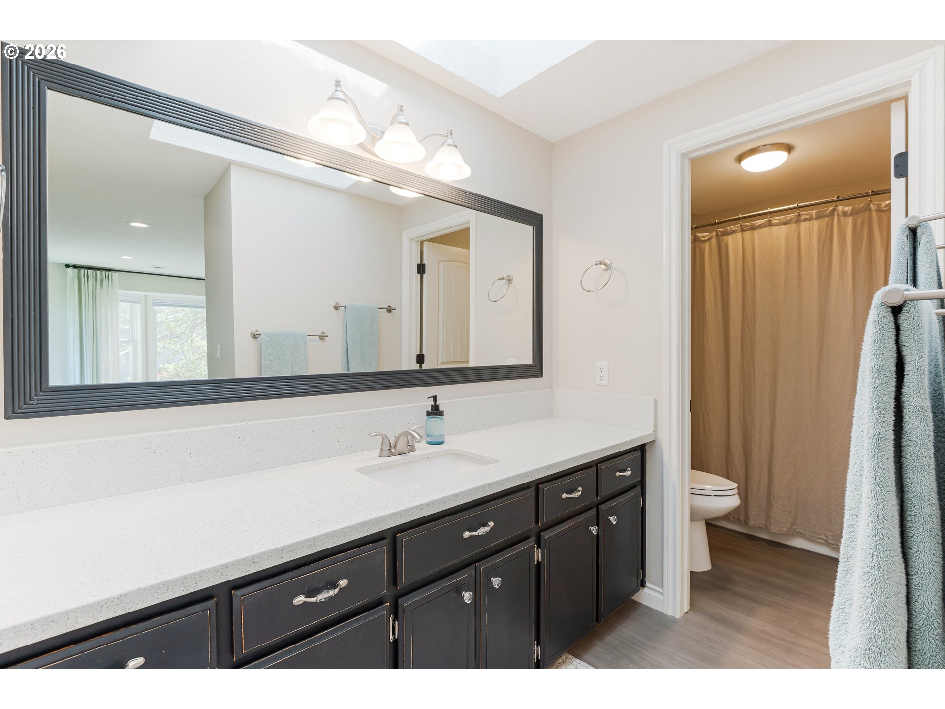 7680 Southwest 182nd Place Beaverton, OR 97007 - Photo 16 of 33 a bathroom with a double vanity sink a toilet and a mirror