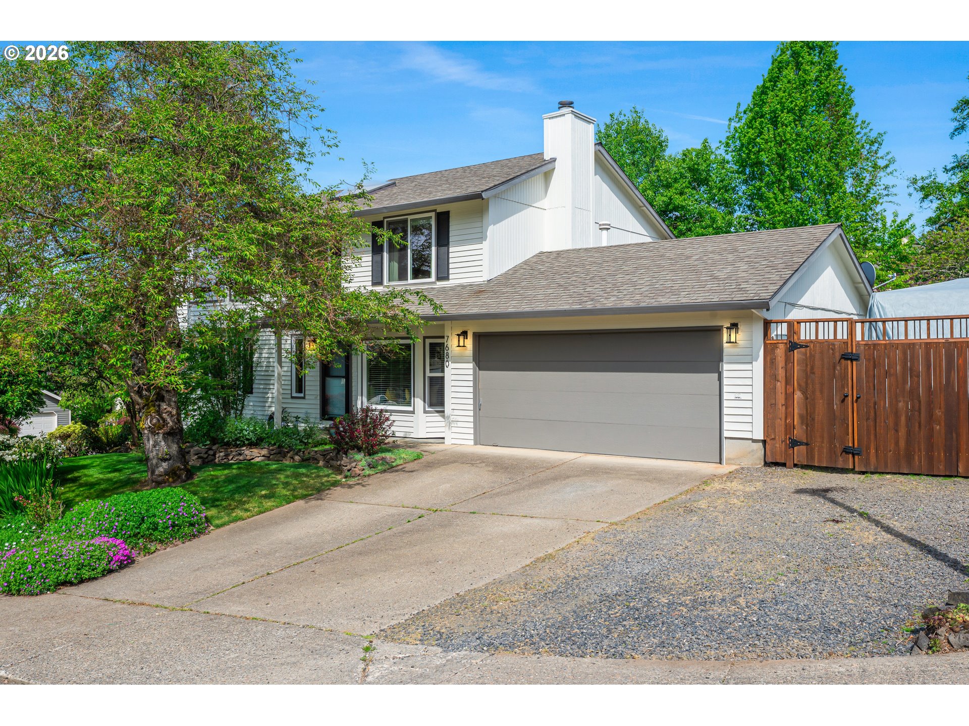 7680 Southwest 182nd Place Beaverton, OR 97007 - Photo 24 of 33 a front view of a house with a yard and garage