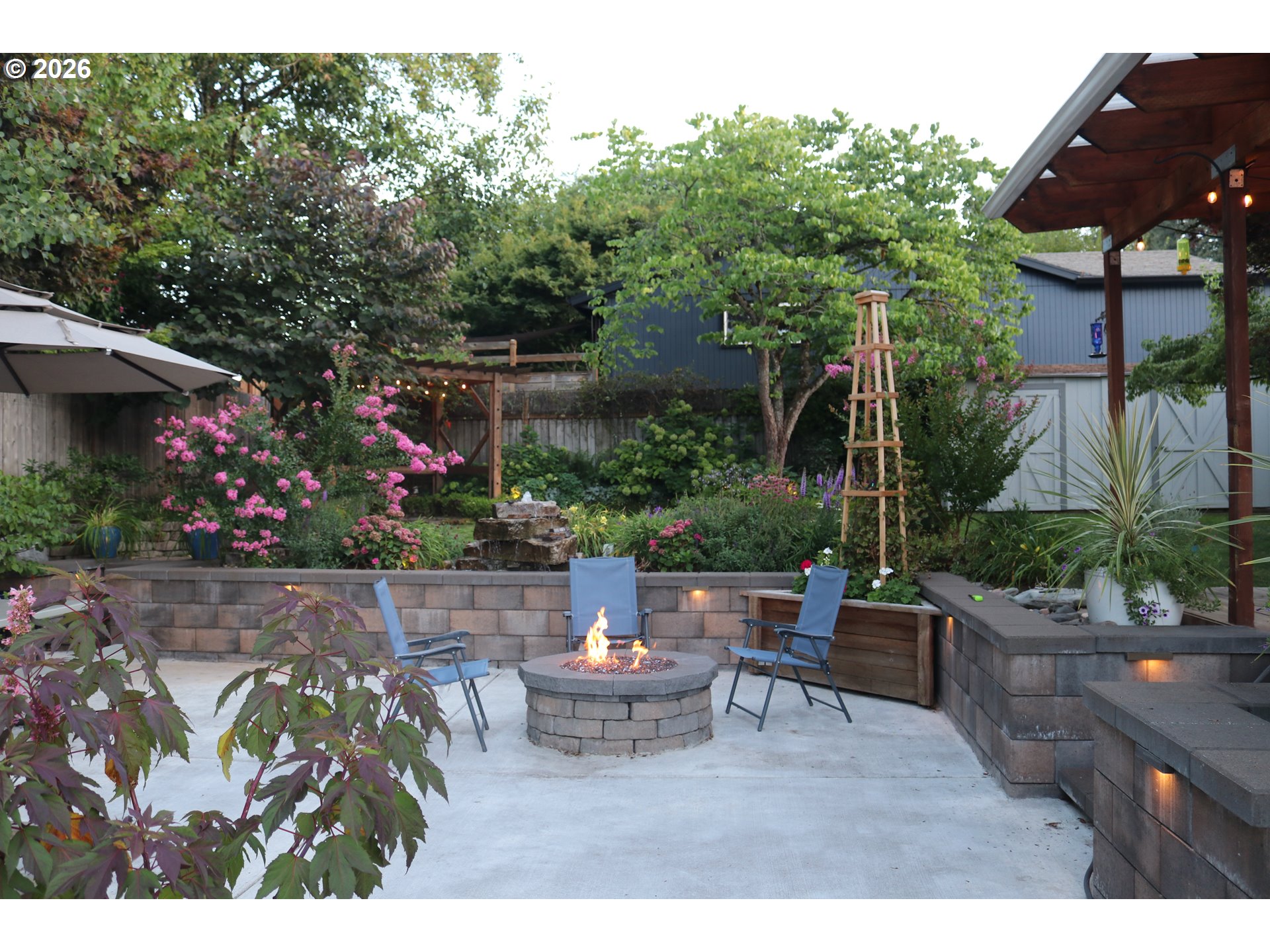 7680 Southwest 182nd Place Beaverton, OR 97007 - Photo 27 of 33 a view of yard with seating area and trees in the background