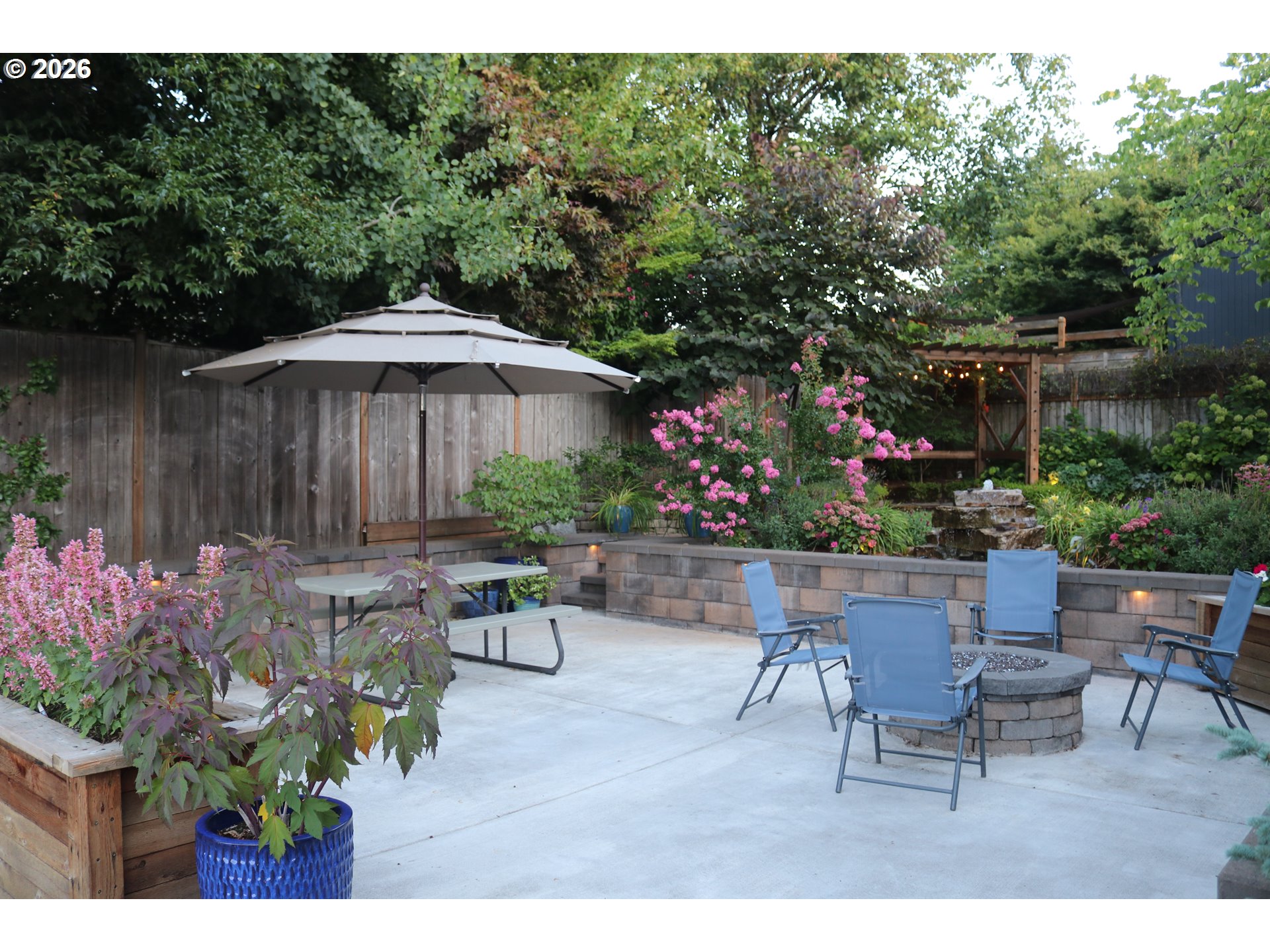 7680 Southwest 182nd Place Beaverton, OR 97007 - Photo 28 of 33 a backyard of a house with a table and chairs
