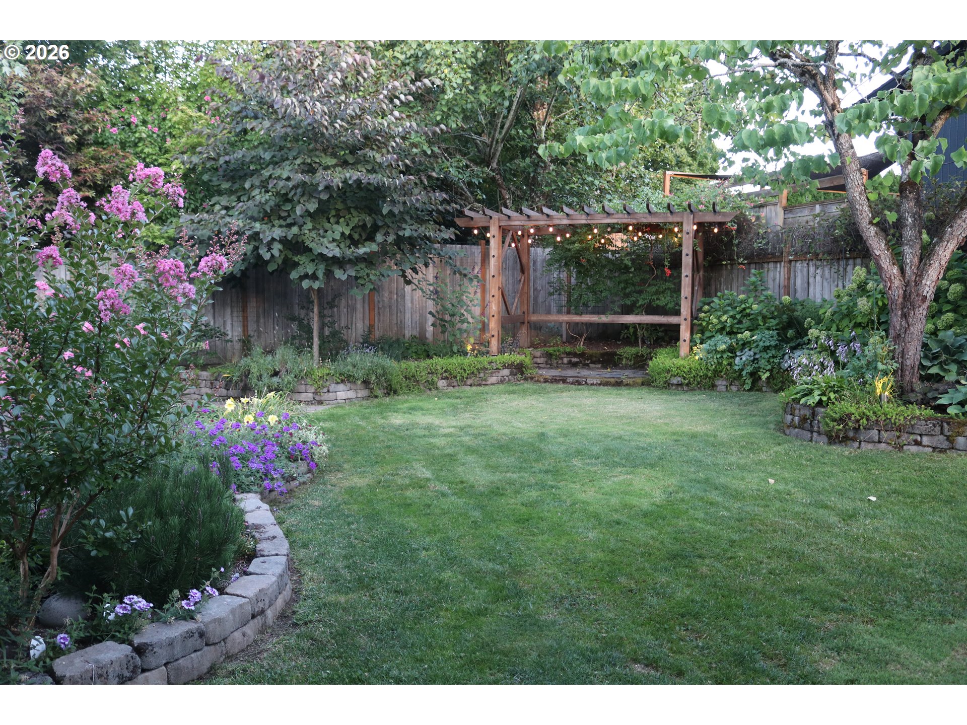 7680 Southwest 182nd Place Beaverton, OR 97007 - Photo 32 of 33 a view of a backyard with potted plants and large trees