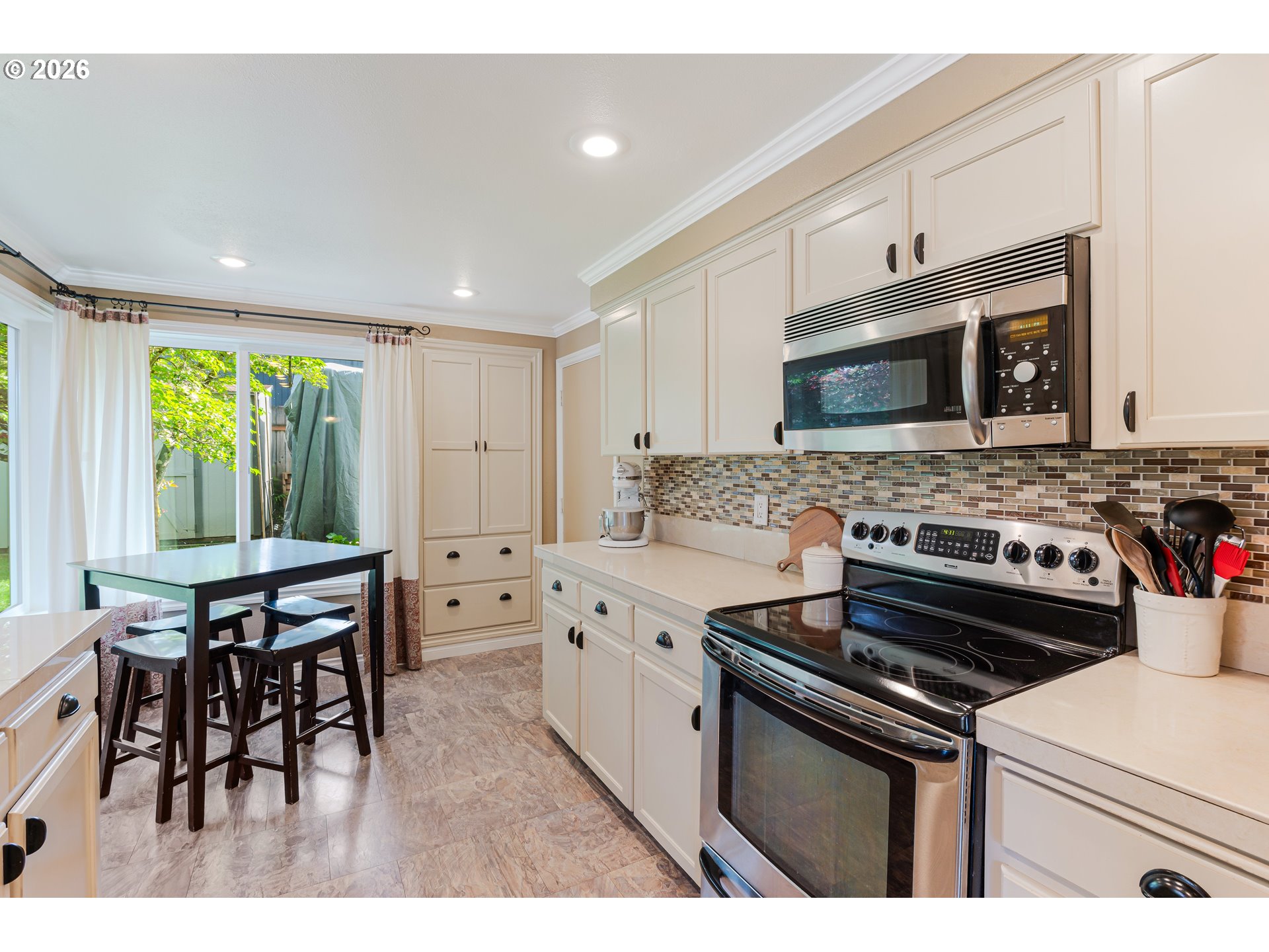 7680 Southwest 182nd Place Beaverton, OR 97007 - Photo 9 of 33 a kitchen with stainless steel appliances a stove microwave and cabinets