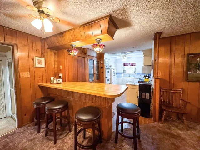 a view of a dining room with furniture and a chandelier