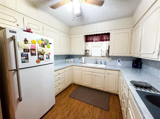 a kitchen with stainless steel appliances a refrigerator and microwave