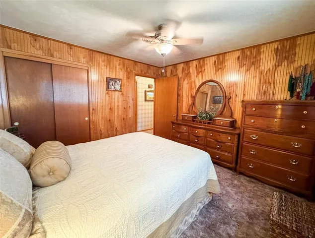 a bedroom with a large bed and a dresser