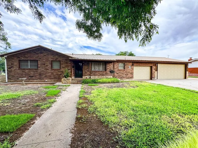 a front view of house with yard and green space