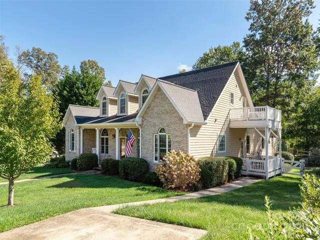 a view of house that has a yard