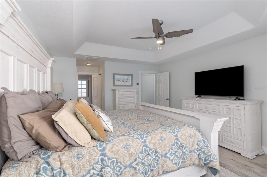193 Beeney Road Southeast Port Charlotte, FL 33952 - Photo 12 of 45 a bedroom with a bed and a flat screen tv