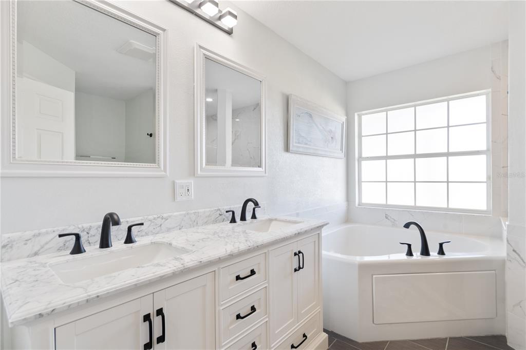 193 Beeney Road Southeast Port Charlotte, FL 33952 - Photo 13 of 45 a bathroom with sink two mirror a window and