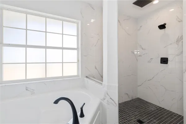 a living room with furniture and potted plant