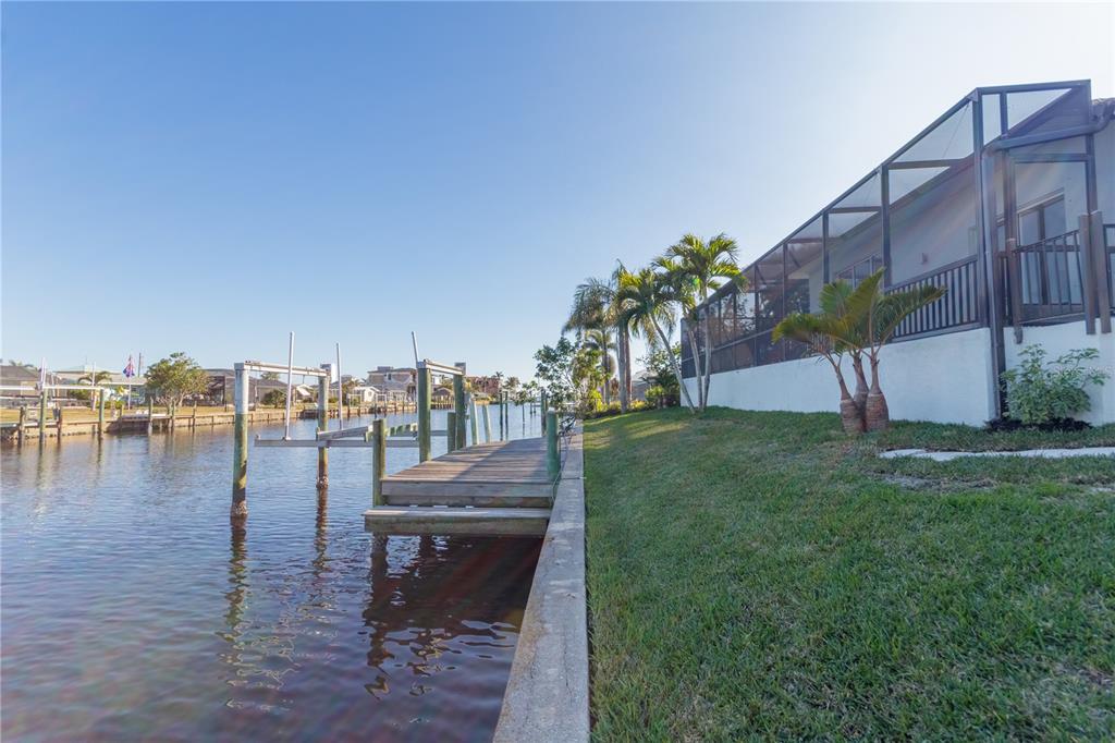 193 Beeney Road Southeast Port Charlotte, FL 33952 - Photo 35 of 45 a view of a lake with couches and wooden floor