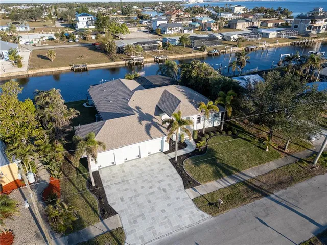 an aerial view of a house with garden space and street view