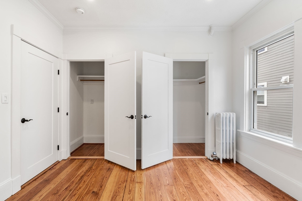 93 Sydney Street, Unit 3 Boston, MA 02125 - Photo 14 of 28 a view of a hallway with wooden floor and closet area