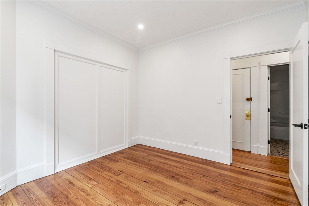 93 Sydney Street, Unit 3 Boston, MA 02125 - Photo 21 of 28 a view of empty room with wooden floor
