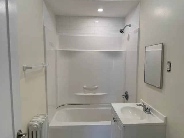 a bathroom with a bathtub and shower