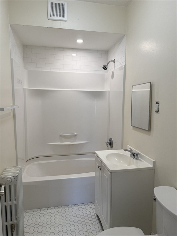 93 Sydney Street, Unit 3 Boston, MA 02125 - Photo 7 of 28 a bathroom with a bathtub a sink a toilet and a mirror