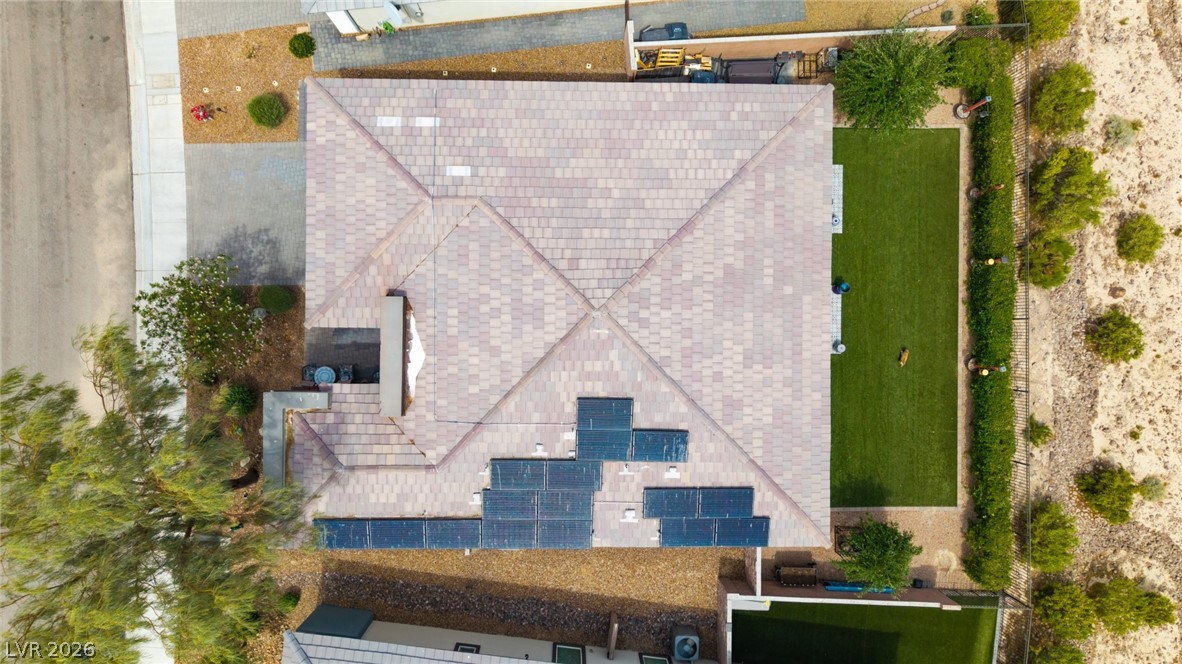 4914 East Beacon Ridge Drive Pahrump, NV 89061 - Photo 32 of 34 An aerial perspective reveals the home's patterned roof, solar panels, and meticulously maintained yard.